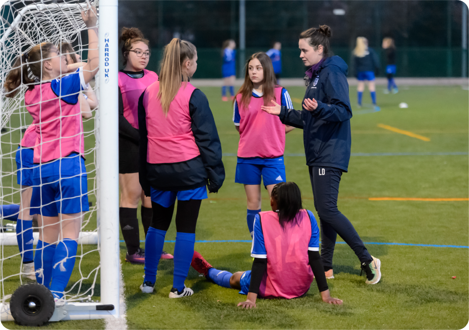 A female football coach coaching her female players