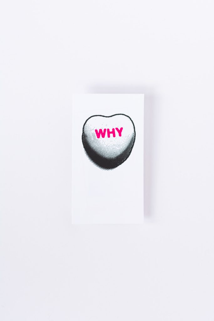 A greyscale heart with a pink 'Why' printed on it